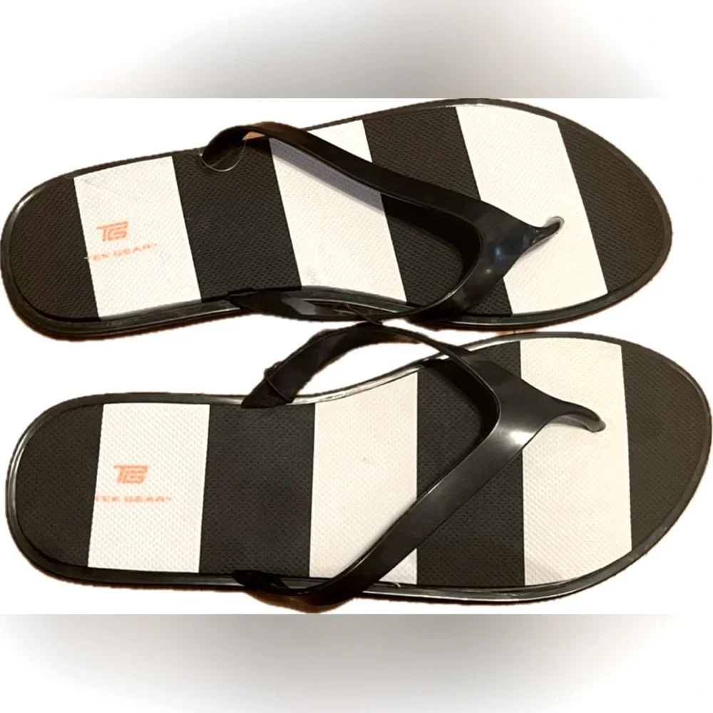 Tek Gear black and white flip flops. New with tag. Women’s size L (9-10)